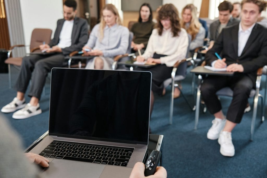 A person delivering a conference paper to an audience.