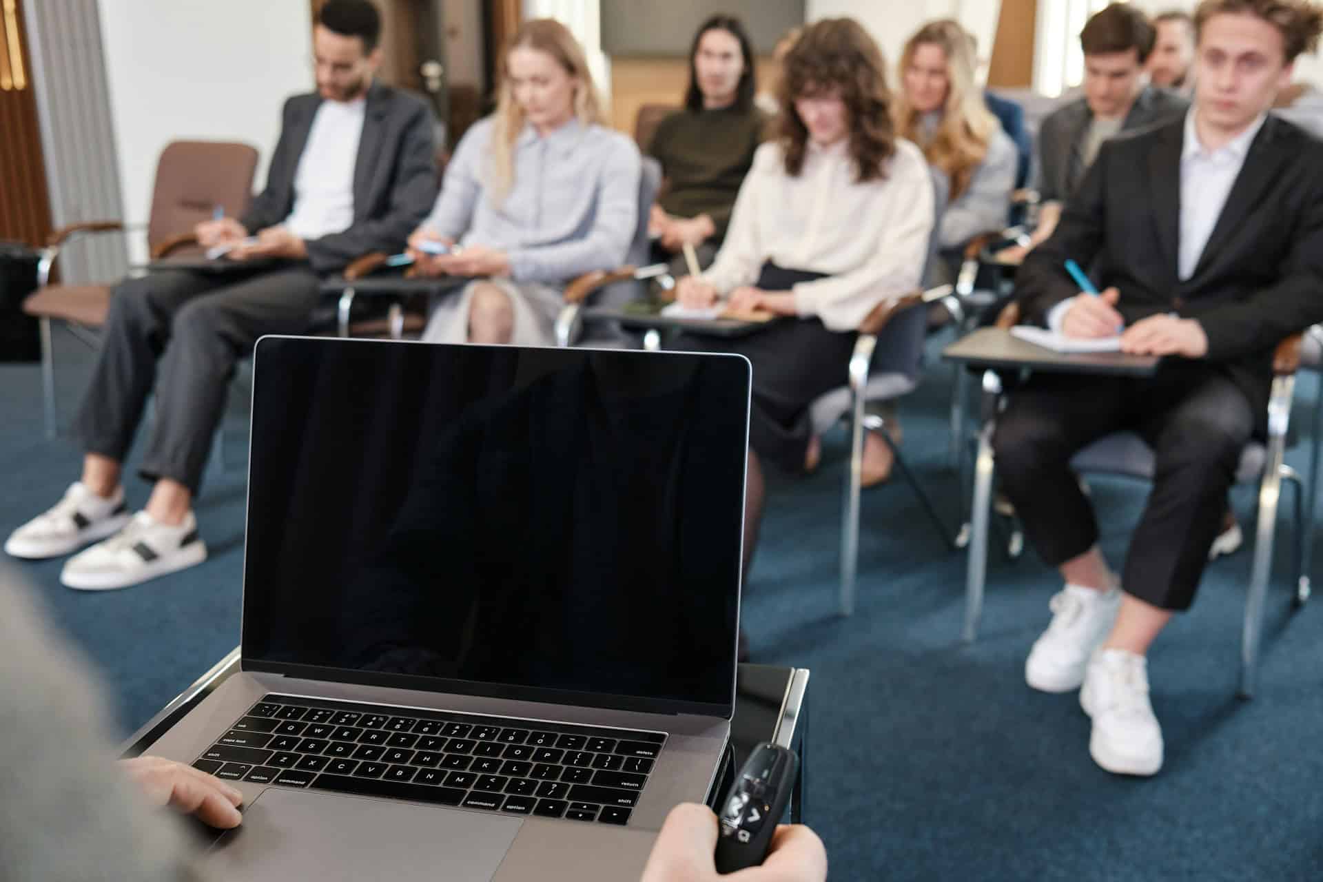 A person delivering a conference paper to an audience.