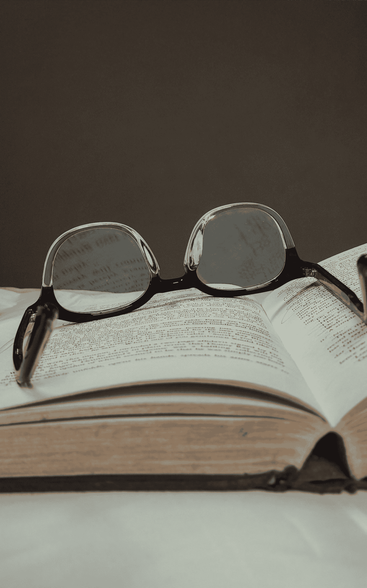 Glasses on a book.(Article: Publish your nonfiction book with our publishing house!)
