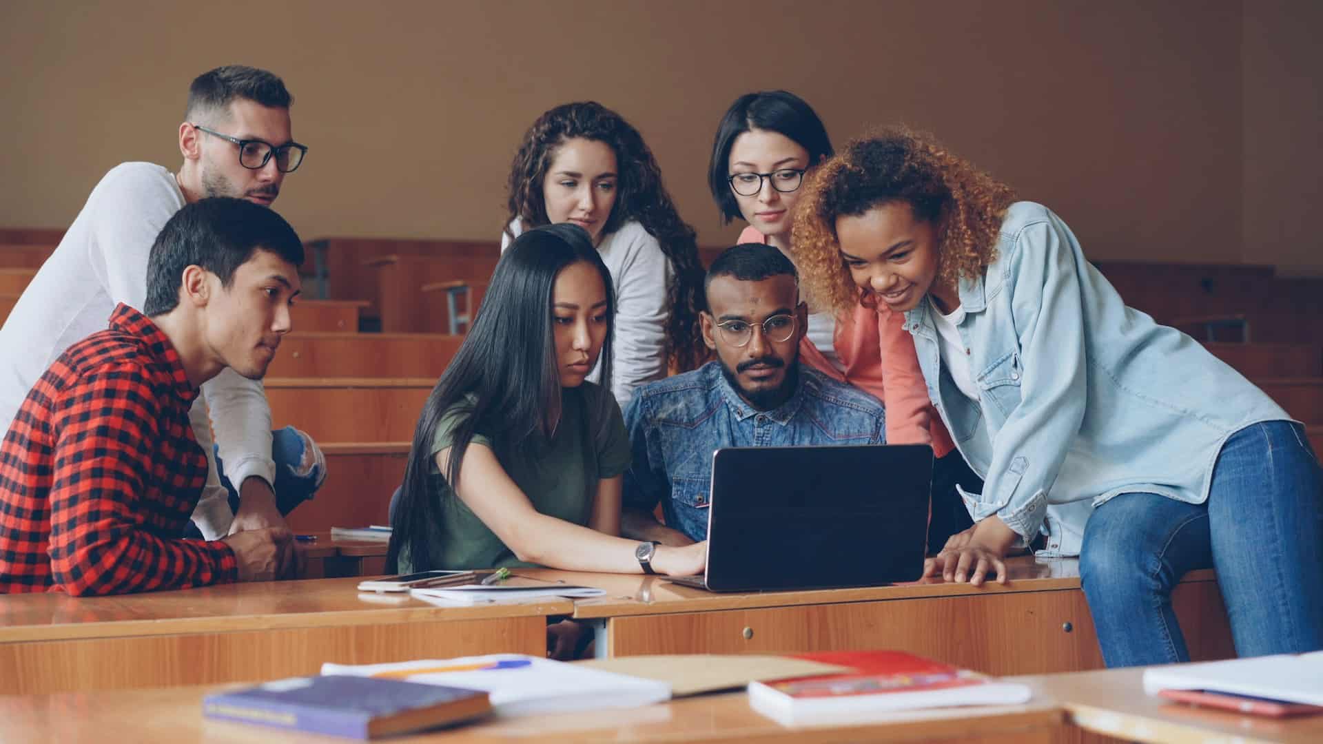 A group of academics creating a research blog on their laptop.