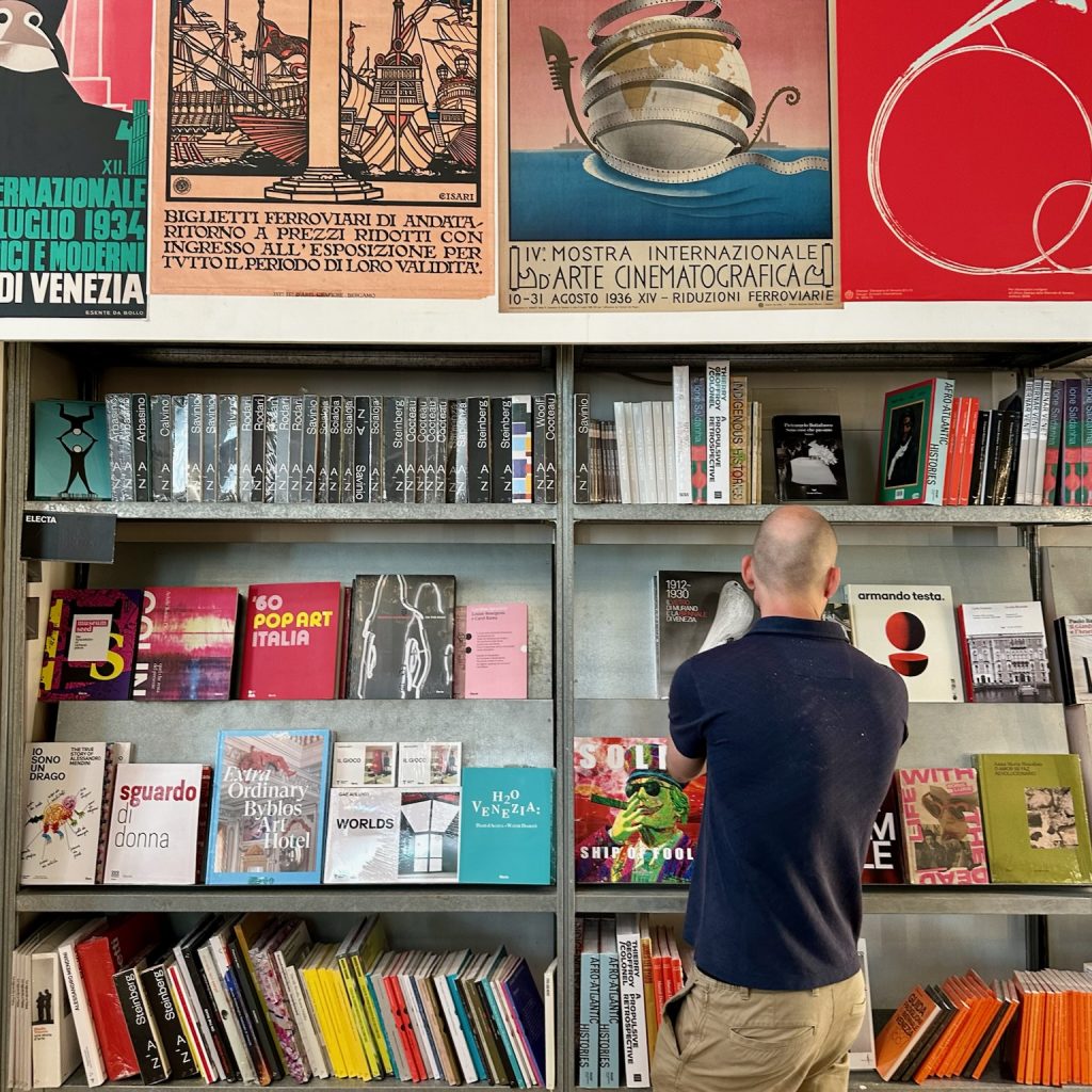 A man browsing art exhibition catalogues