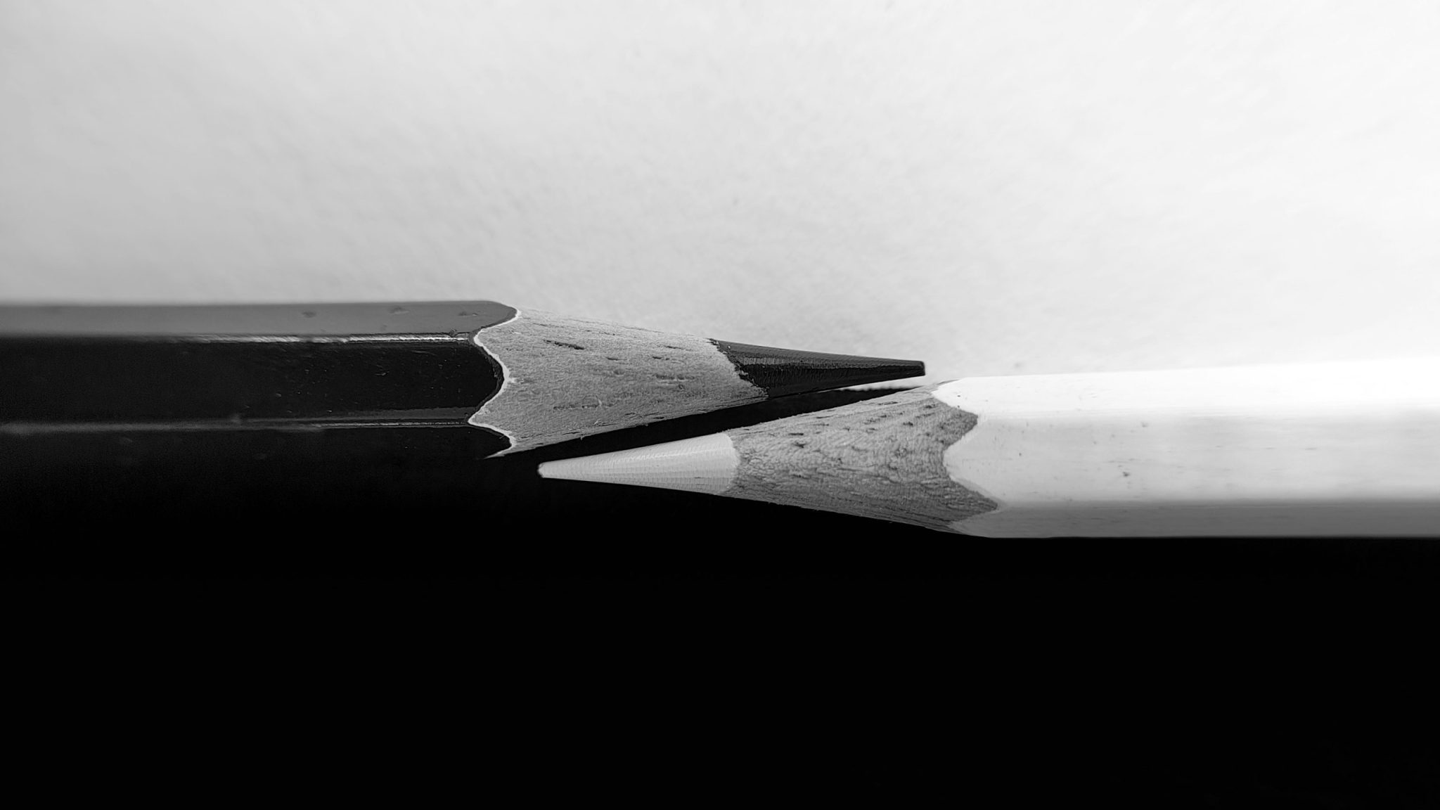 Two pencils, one black, one white. The black represents nonfiction authors published at Flatpage, whereas the white represents our expertise in editorial services for nonfiction authors.