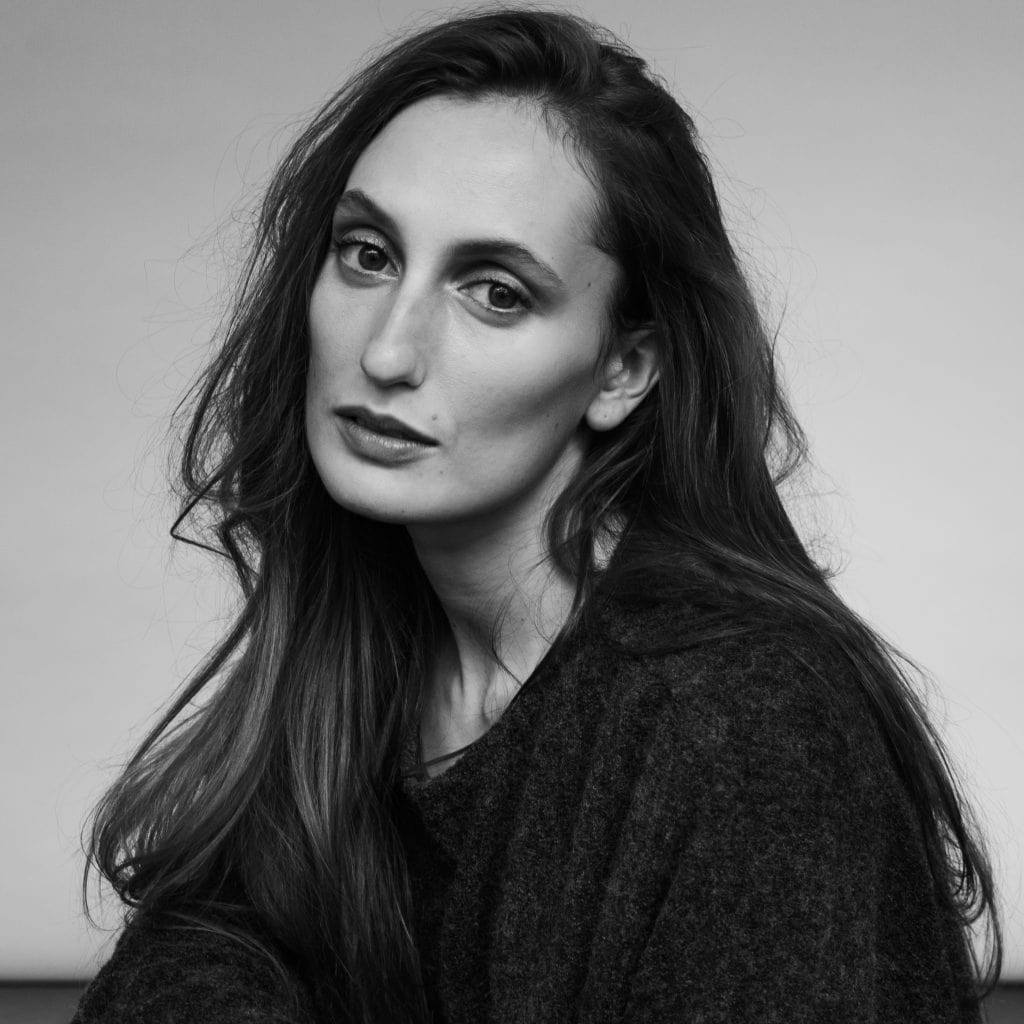 A fair skinned woman with long dark hair